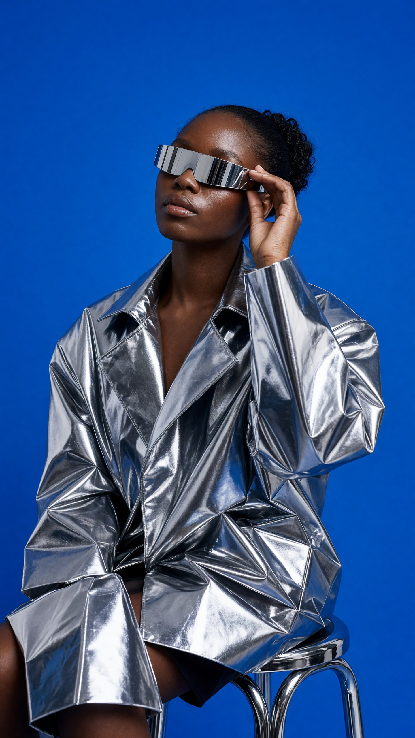 editorial studio portrait grok imagine image v2 prompt showing a silver jacket in a cobalt studio
